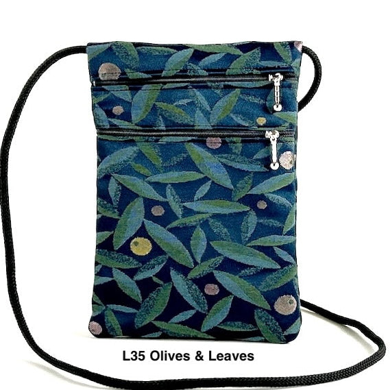 A small cross-body bag with three zipper compartments and an adjustable strap, available in multicolored patterns.